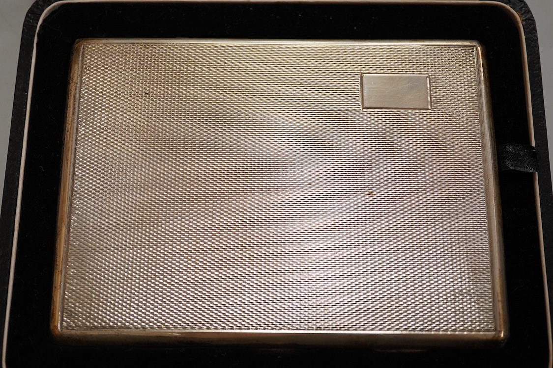 A cased engine turned sterling cigarette case, 11.4cm, a George V silver cigarette case and a cased commemorative limited edition silver gilt Churchill Centenary Picture Medal.